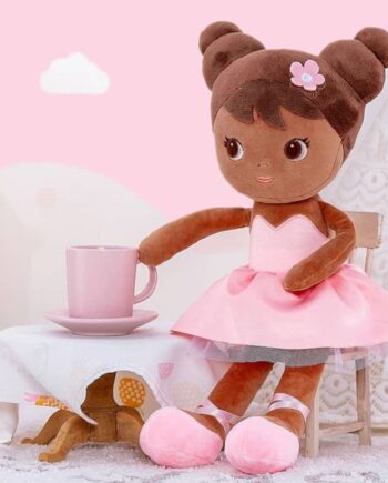 melina the magical princess is a plush doll with brown skin and hair styled in two buns, wearing a pink dress and ballet shoes